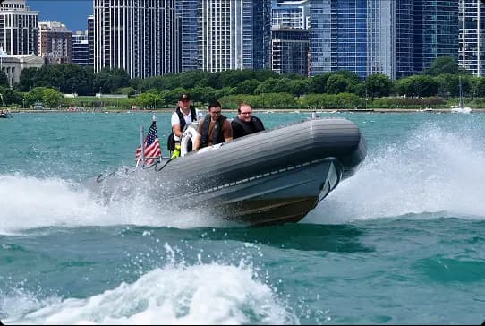 Captain steering the RHIB with downtown Chicago in the background