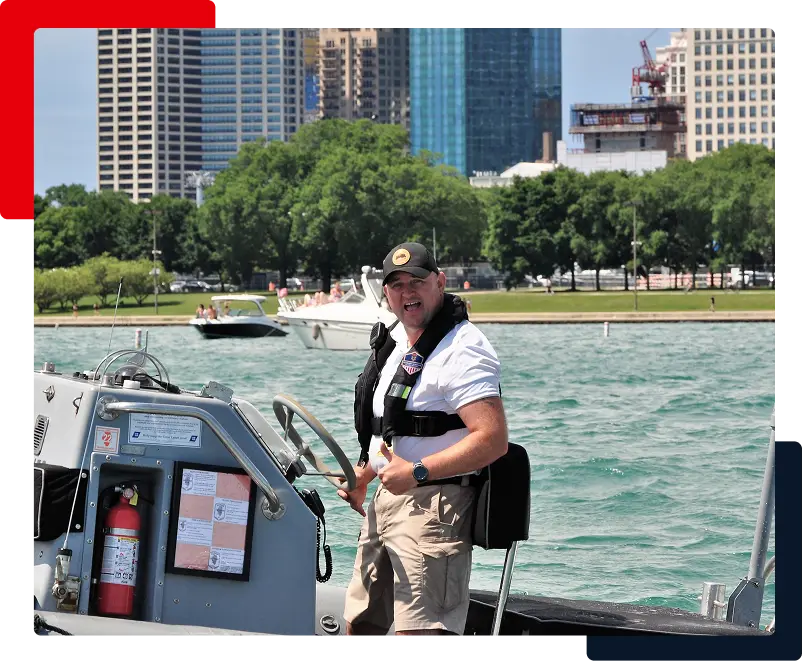 Captain at the helm of a Blackhawk RHIB with the Chicago skyline behind