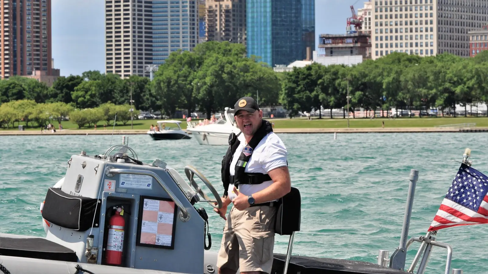 Captain Ken aboard the boat with the Chicago skyline behind him
