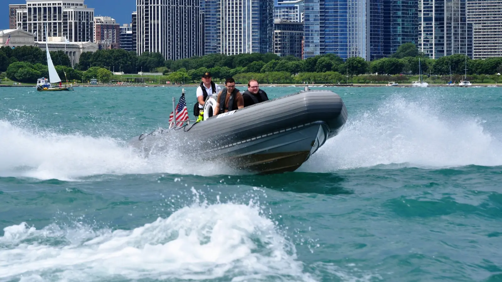 Blackhawk RHIB airborne off a wake with the Chicago skyline behind