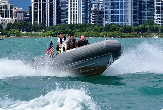Captain steering the RHIB with downtown Chicago in the background